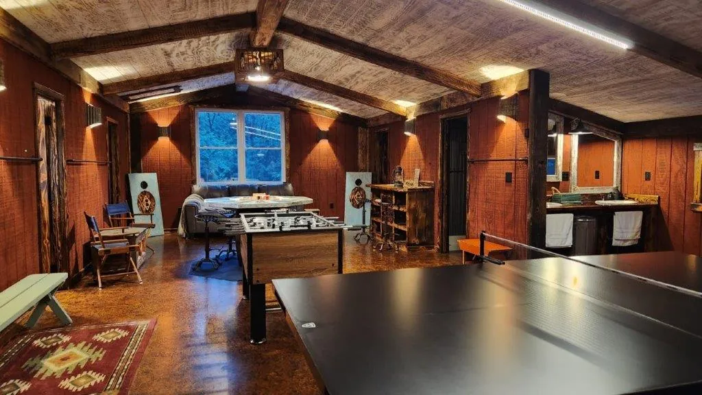 Loft game room with cornhole boards and foosball