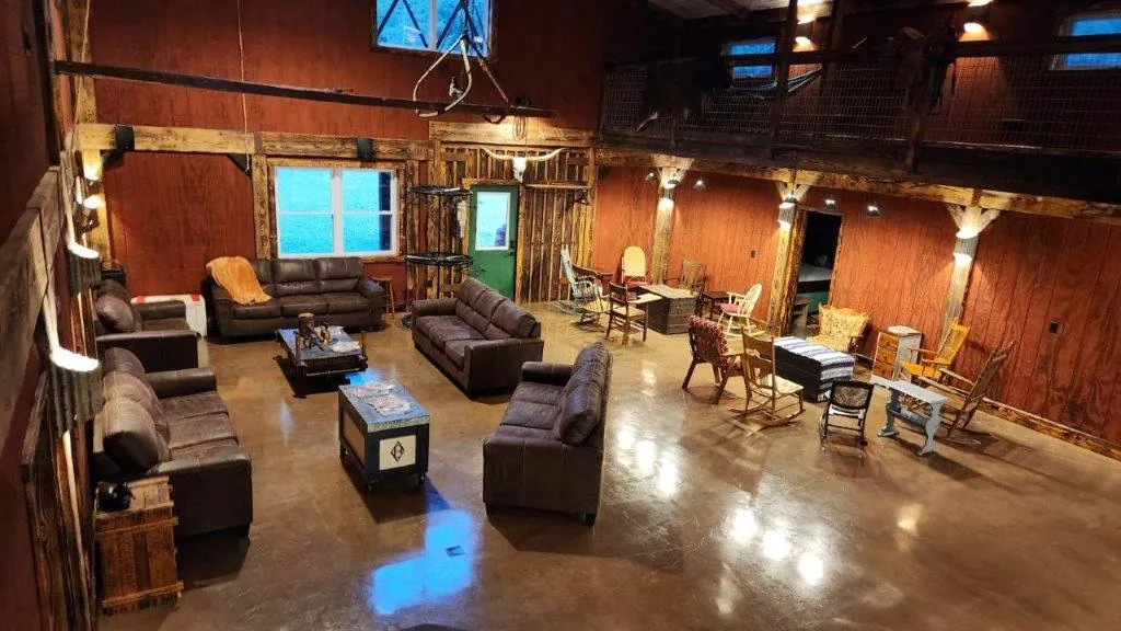 Main living area with leather sofas, rocking chairs, and open floor