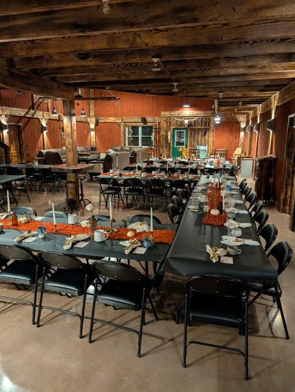 Banquet tables set for a group dinner with fall decorations