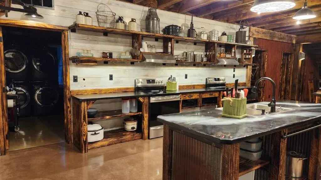 Kitchen counter with ranges, open shelving, and prep area